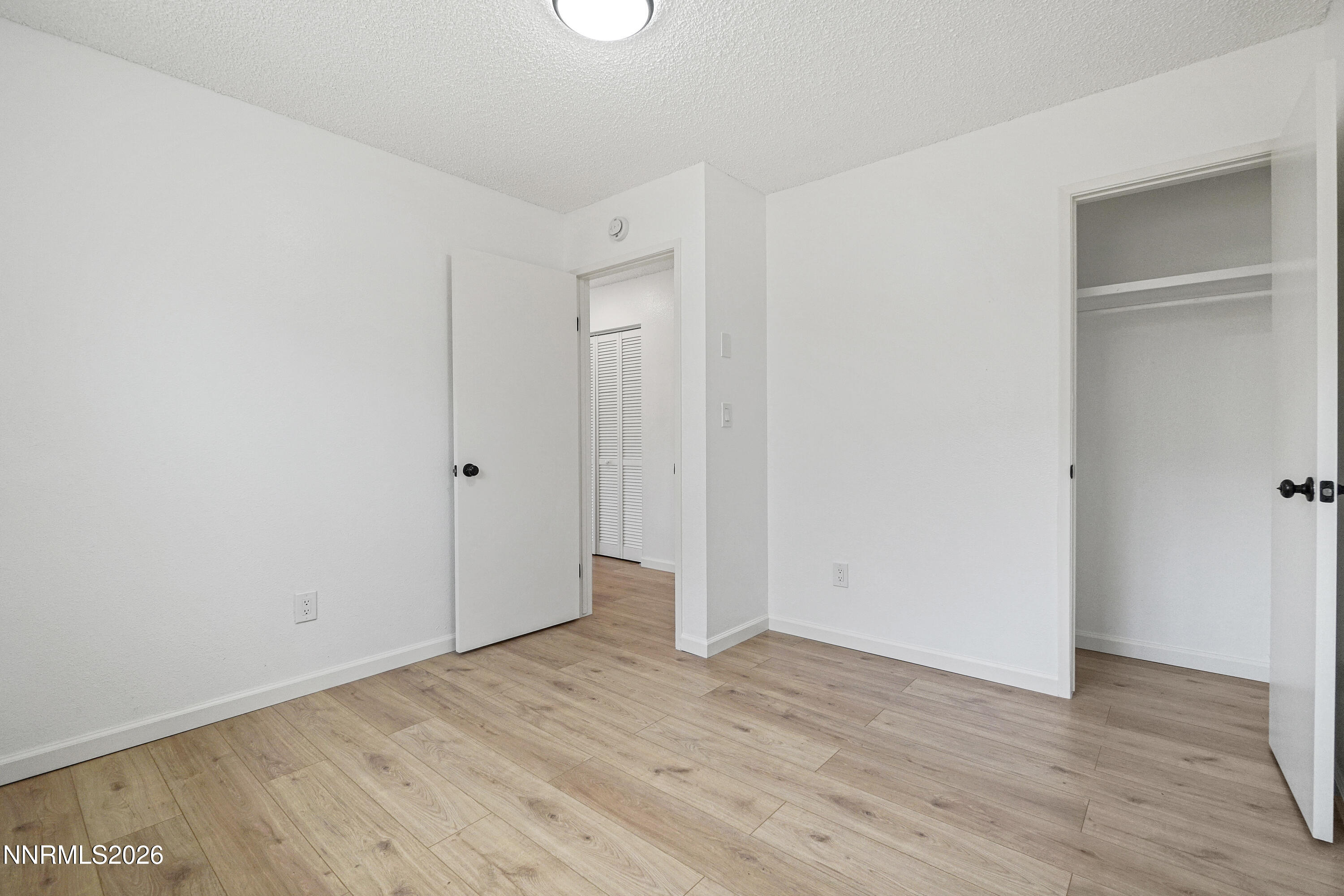 535 Churchill Street Fallon, NV 89406 - Photo 10 of 19 a view of an empty room with wooden floor