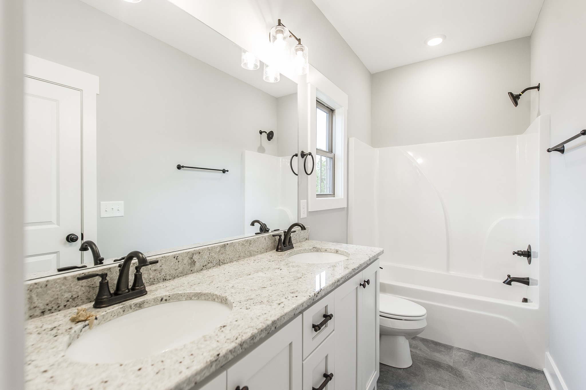 511 Clearview Road Cottontown, TN 37048 - Photo 31 of 41 a bathroom with a granite countertop sink a toilet and shower