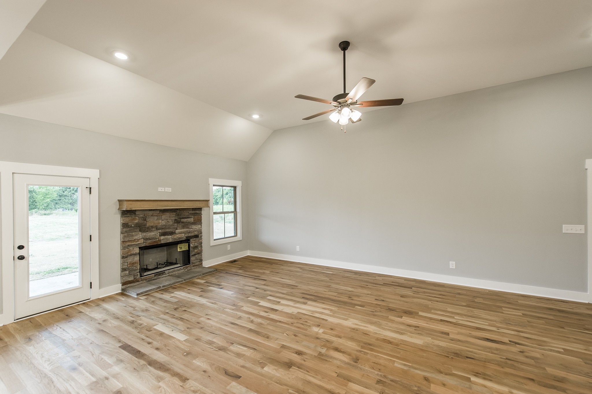 511 Clearview Road Cottontown, TN 37048 - Photo 9 of 41 an empty room with fireplace fan and windows