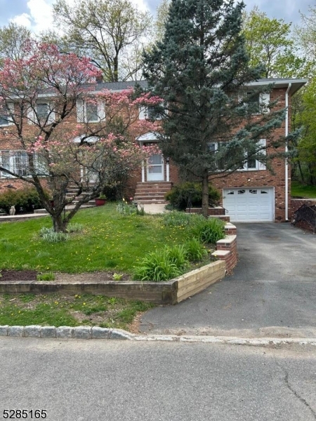 a view of a house with a garden and pathway