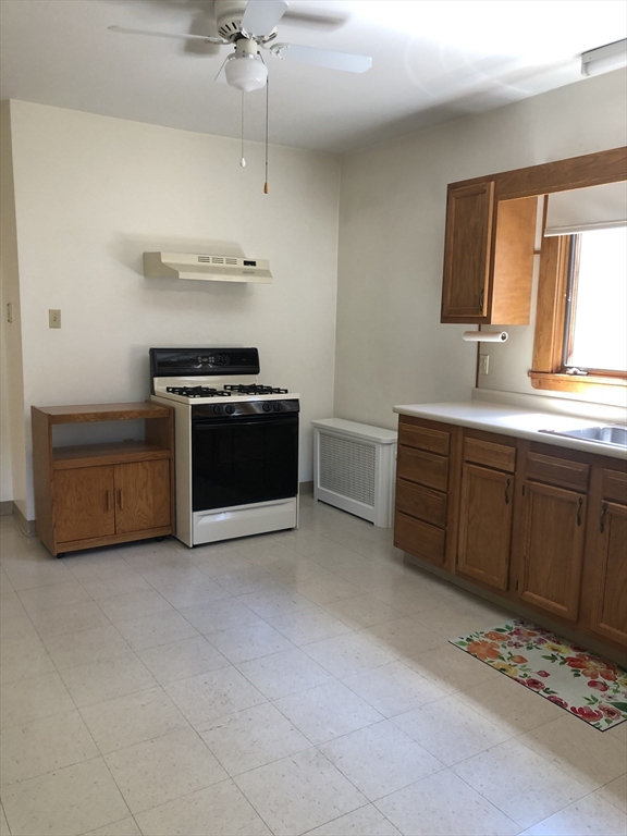 64 Freeman Street, Unit 1 Arlington, MA 02474 - Photo 2 of 9 a kitchen with a sink and a stove