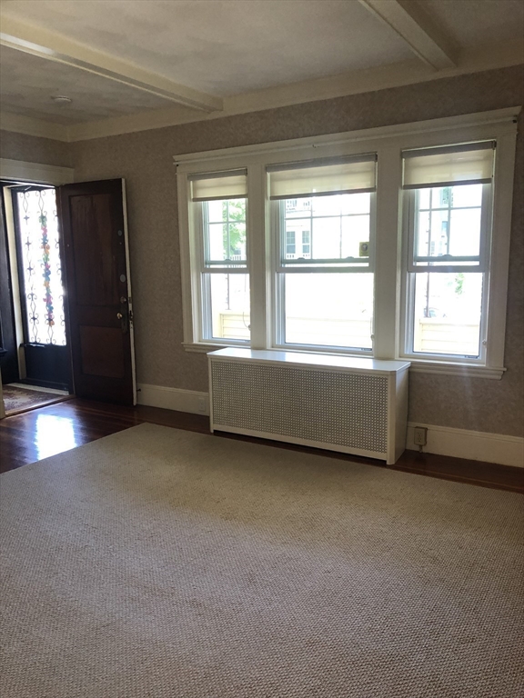 64 Freeman Street, Unit 1 Arlington, MA 02474 - Photo 4 of 9 an empty room with a window