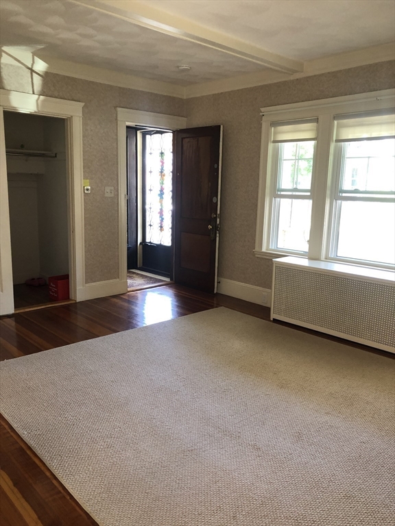 64 Freeman Street, Unit 1 Arlington, MA 02474 - Photo 5 of 9 an empty room with windows
