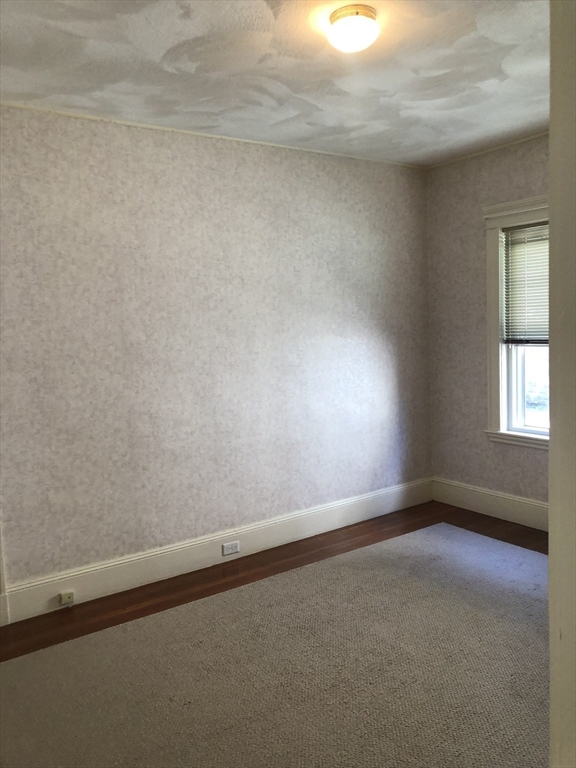64 Freeman Street, Unit 1 Arlington, MA 02474 - Photo 7 of 9 a view of an empty room and window