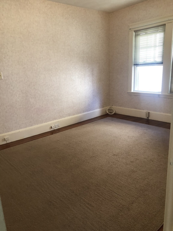 64 Freeman Street, Unit 1 Arlington, MA 02474 - Photo 8 of 9 an empty room with a window
