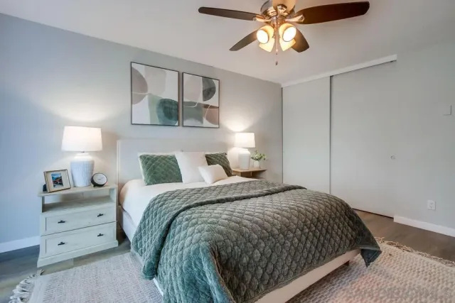 a bedroom with a bed and wooden floor