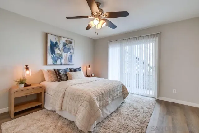 a bedroom with bed and a chandelier