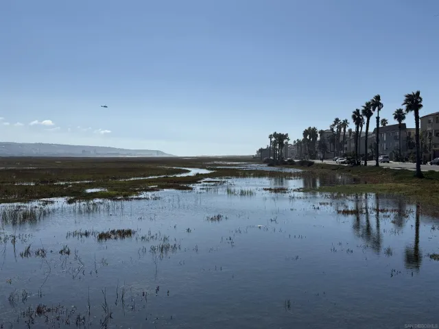 a view of a lake with houses in the back