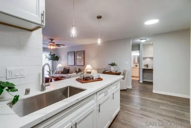 a view of a kitchen island a sink and living room