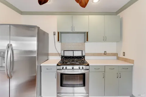a kitchen with stainless steel appliances a sink a stove and cabinets