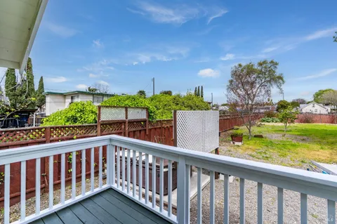 a view of a house with wooden deck and backyard