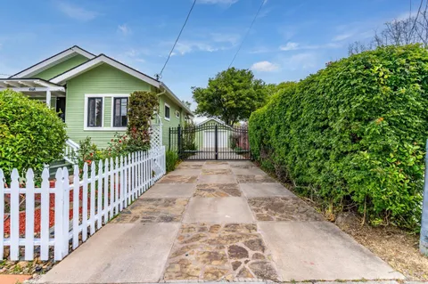 a view of a house with wooden fence
