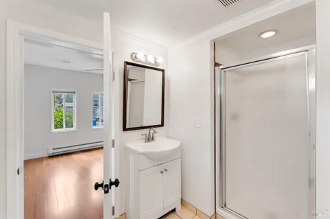a kitchen with a stove cabinets and a wooden floor