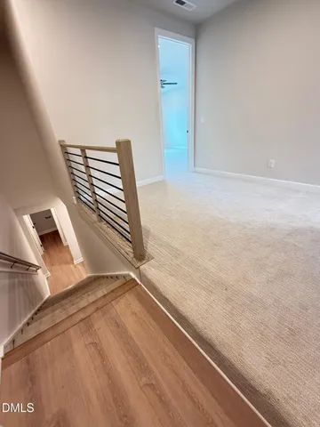 an empty room with a ceiling fan and windows