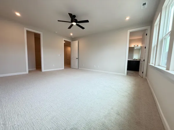 an empty room with windows and entrance