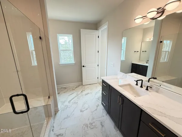a spacious bathroom with a granite countertop sink and a mirror