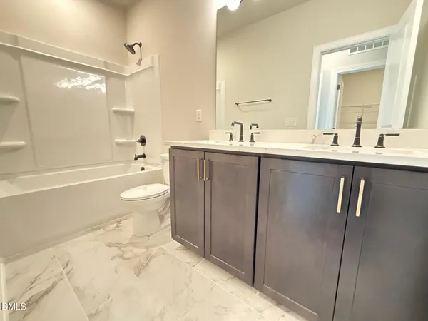 a bathroom with a sink toilet a mirror and shower
