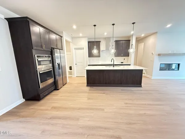 a view of kitchen with sink microwave and refrigerator