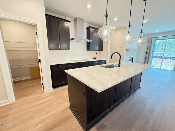 a kitchen with a sink a refrigerator and cabinets
