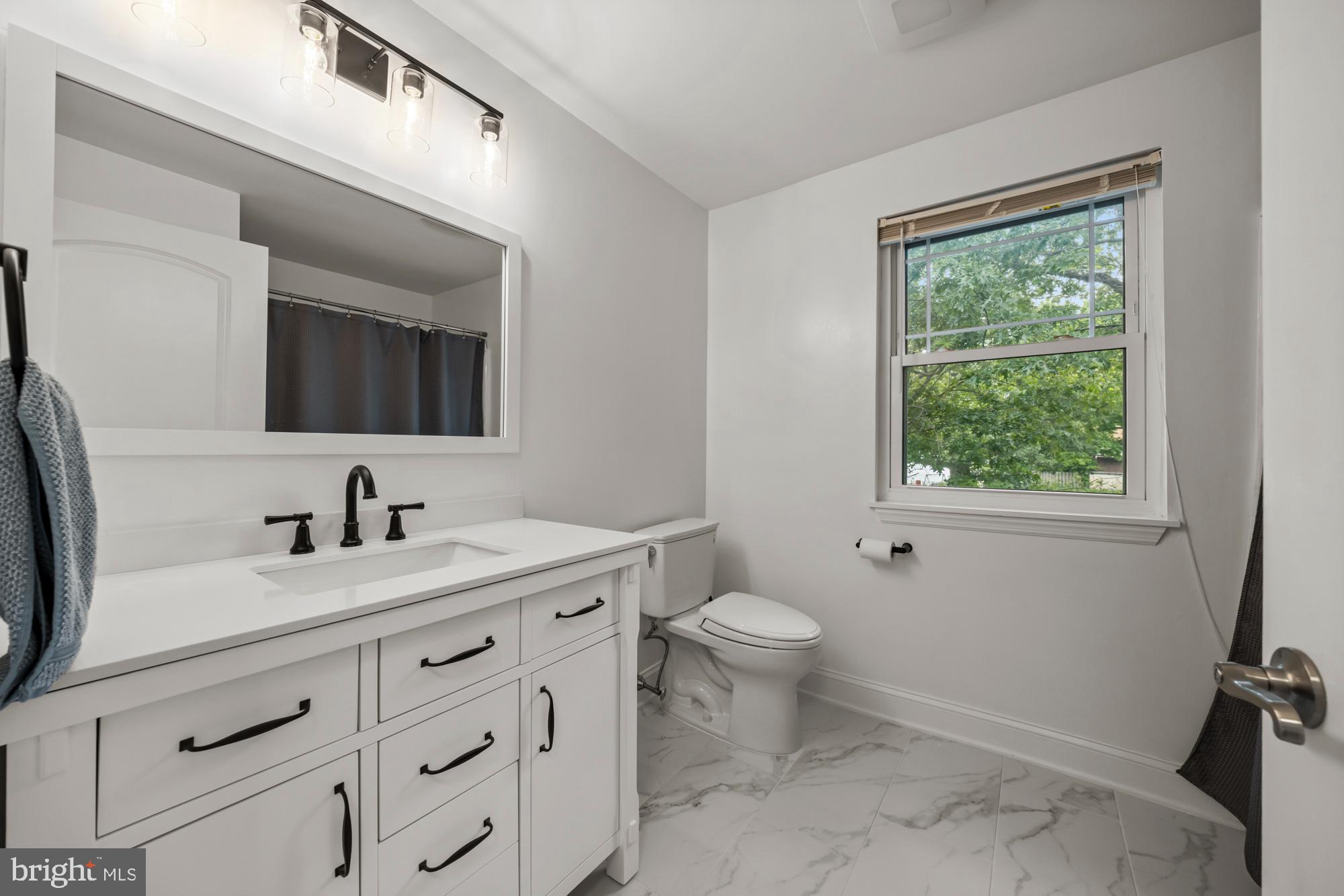 1 Risner Avenue Penns Grove, NJ 08069 - Photo 30 of 45 a bathroom with a toilet a sink a window and mirror