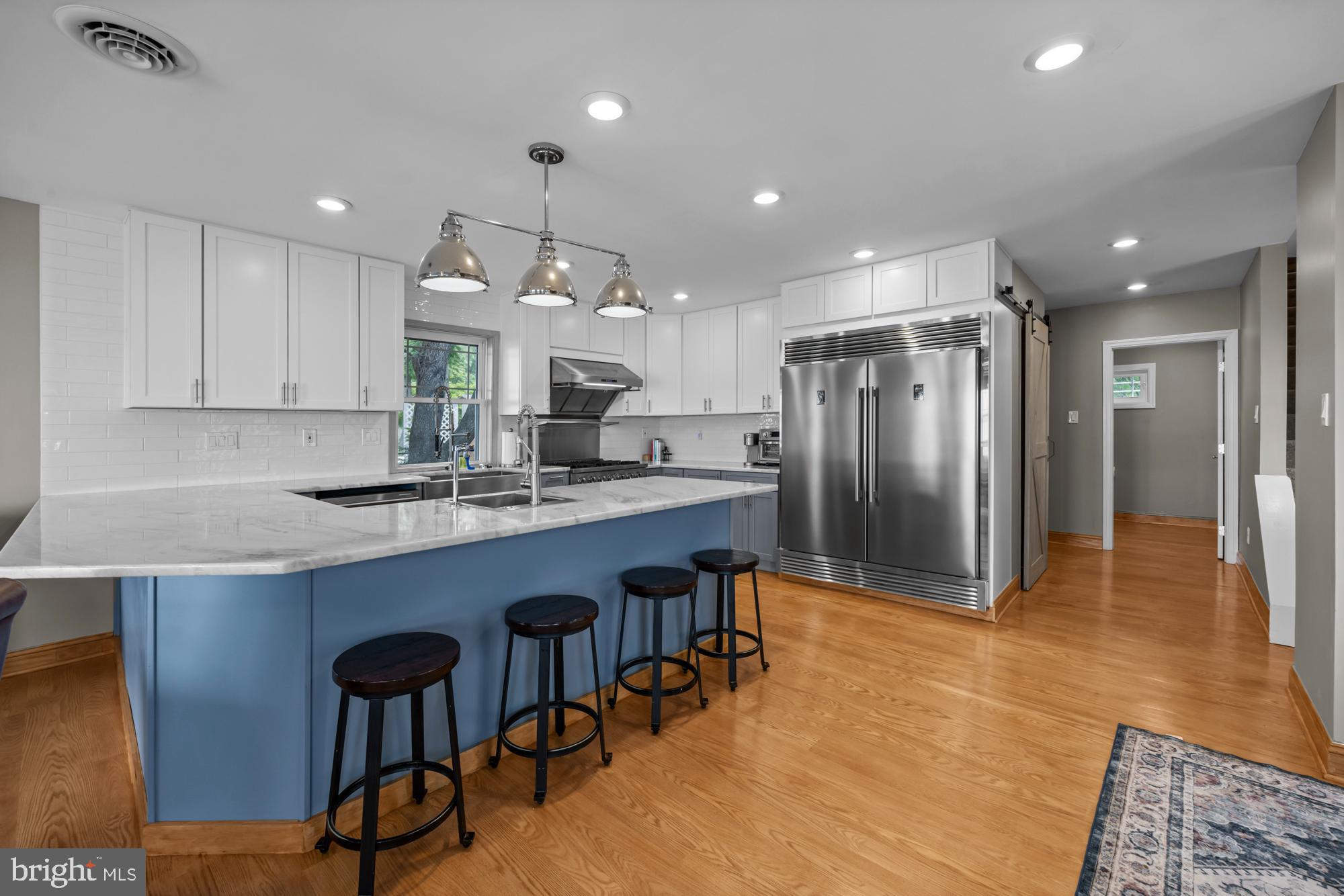 1 Risner Avenue Penns Grove, NJ 08069 - Photo 5 of 45 a kitchen with stainless steel appliances granite countertop a sink a stove a refrigerator and a island with wooden floor