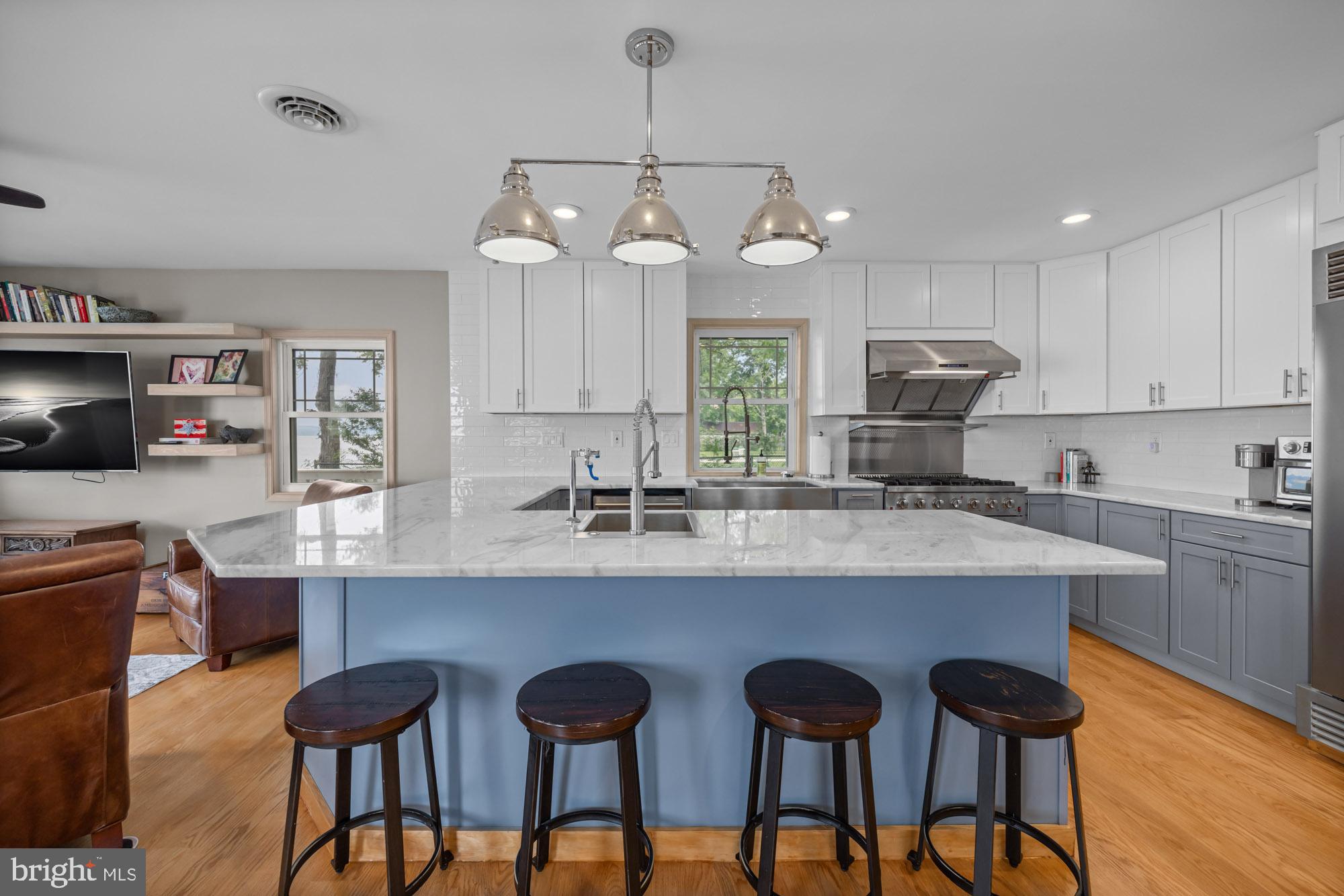 1 Risner Avenue Penns Grove, NJ 08069 - Photo 7 of 45 a kitchen with stainless steel appliances a dining table chairs sink and cabinets