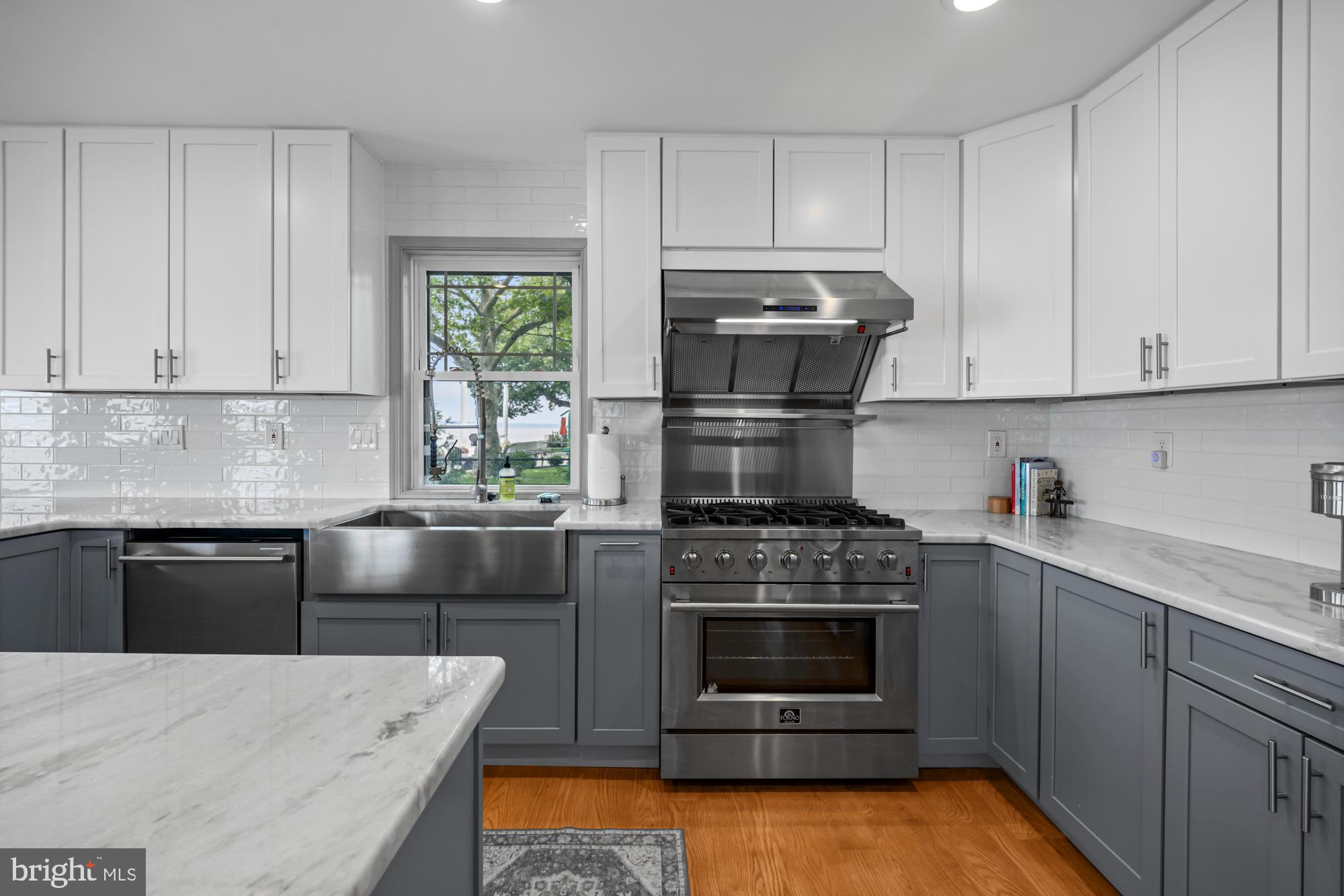 1 Risner Avenue Penns Grove, NJ 08069 - Photo 9 of 45 a kitchen with kitchen island granite countertop a stove sink and cabinets