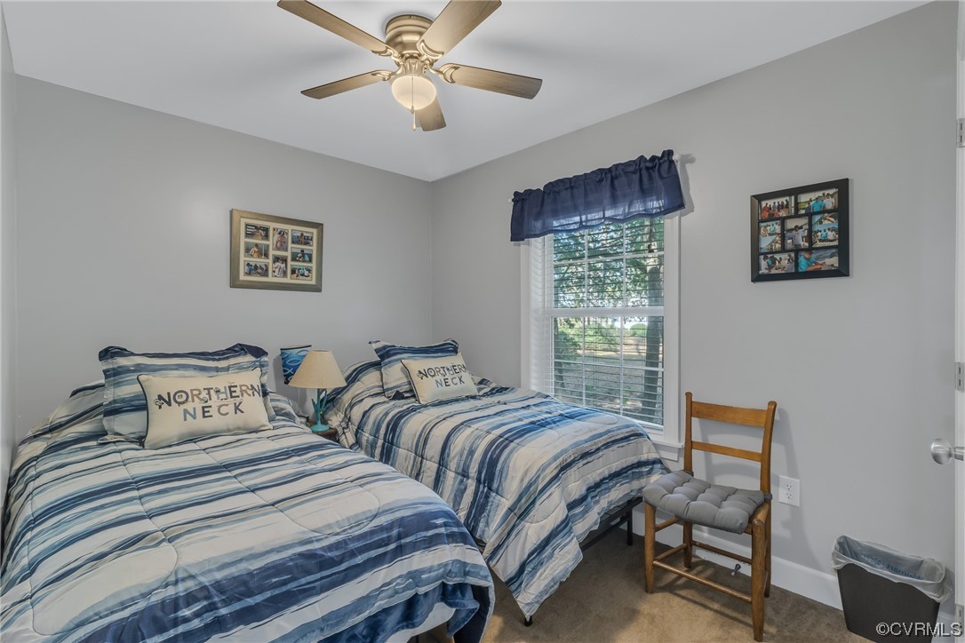 79 Lucom Point Drive Reedville, VA 22539 - Photo 13 of 32 a bedroom with two beds and a window