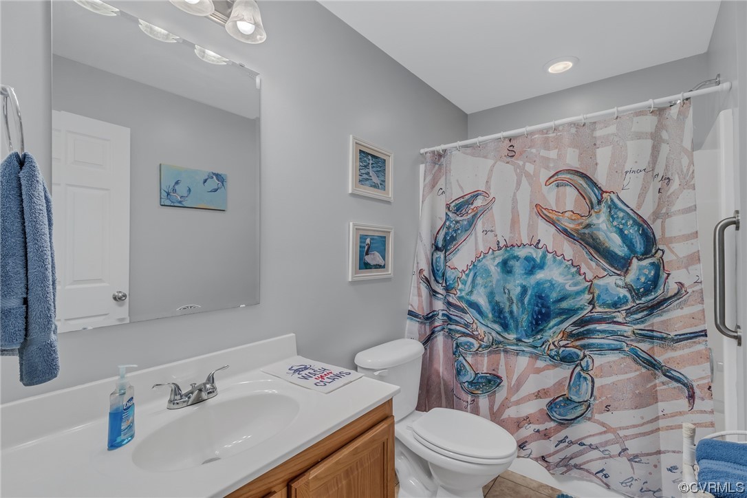 79 Lucom Point Drive Reedville, VA 22539 - Photo 14 of 32 a bathroom with a sink a toilet and a mirror