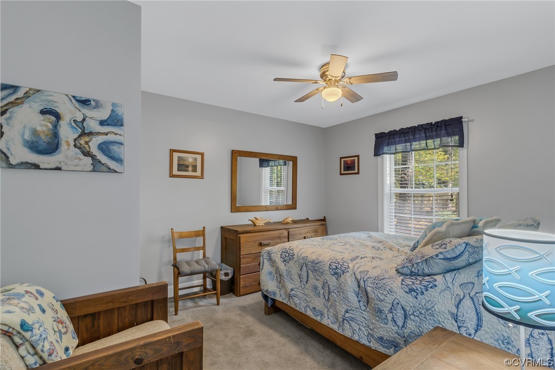 79 Lucom Point Drive Reedville, VA 22539 - Photo 15 of 32 a bedroom with a bed and wooden floor