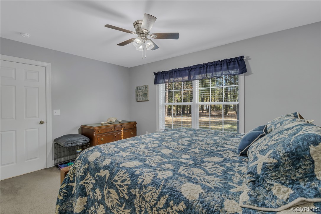79 Lucom Point Drive Reedville, VA 22539 - Photo 16 of 32 a bedroom with a bed and a window