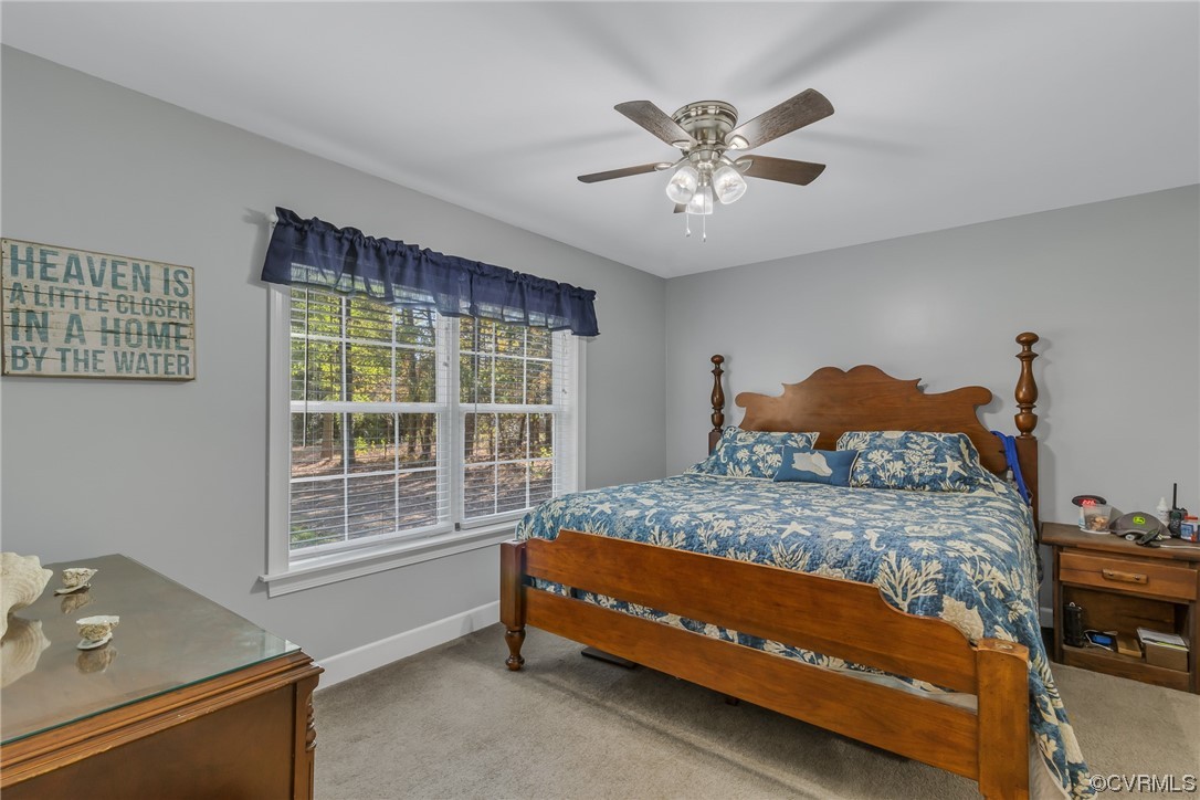 79 Lucom Point Drive Reedville, VA 22539 - Photo 18 of 32 a bedroom with a bed and a window