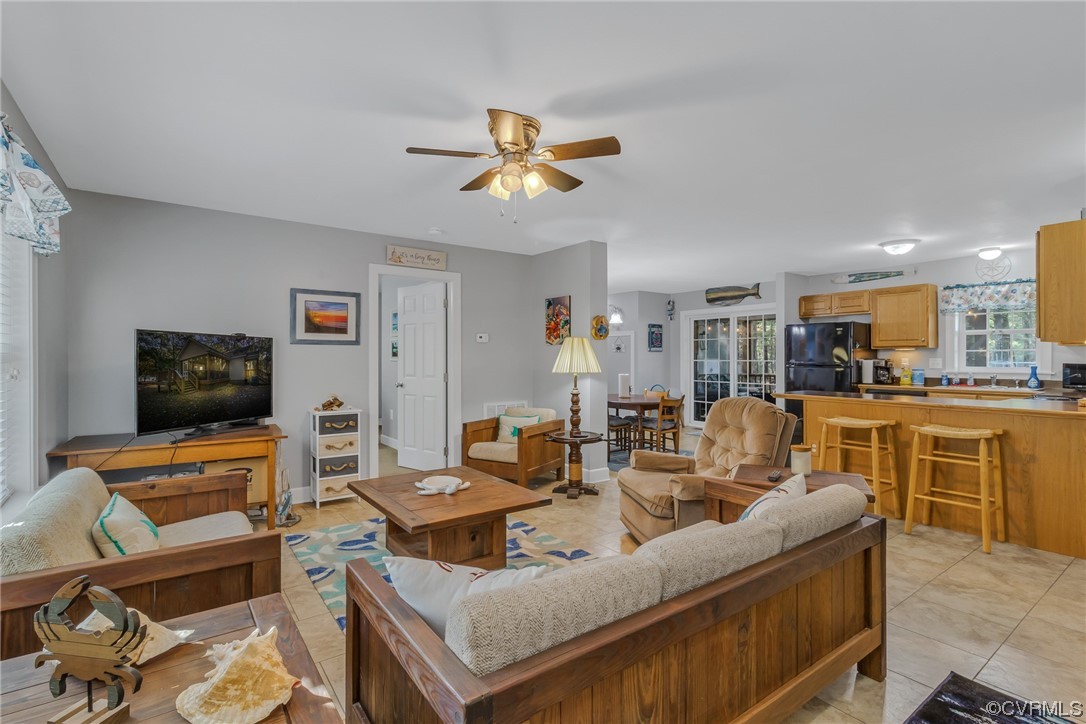 79 Lucom Point Drive Reedville, VA 22539 - Photo 21 of 32 a living room with furniture kitchen view and a fireplace