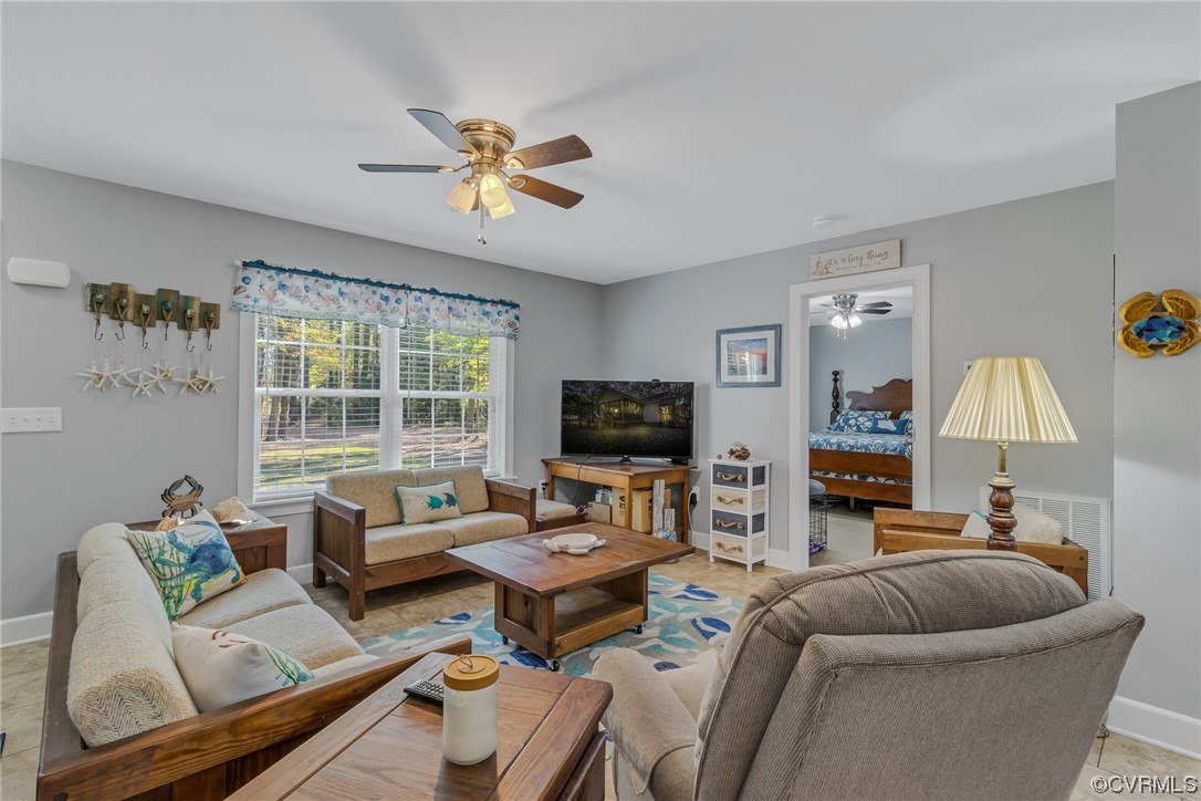 79 Lucom Point Drive Reedville, VA 22539 - Photo 22 of 32 a living room with furniture and a flat screen tv