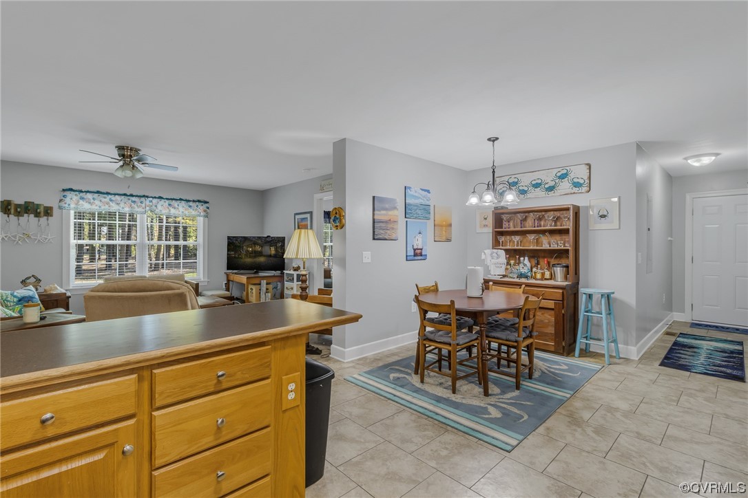79 Lucom Point Drive Reedville, VA 22539 - Photo 24 of 32 a kitchen with a dining table chairs and large window