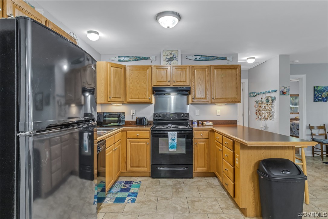 79 Lucom Point Drive Reedville, VA 22539 - Photo 25 of 32 a kitchen with stainless steel appliances granite countertop a stove a refrigerator and a sink