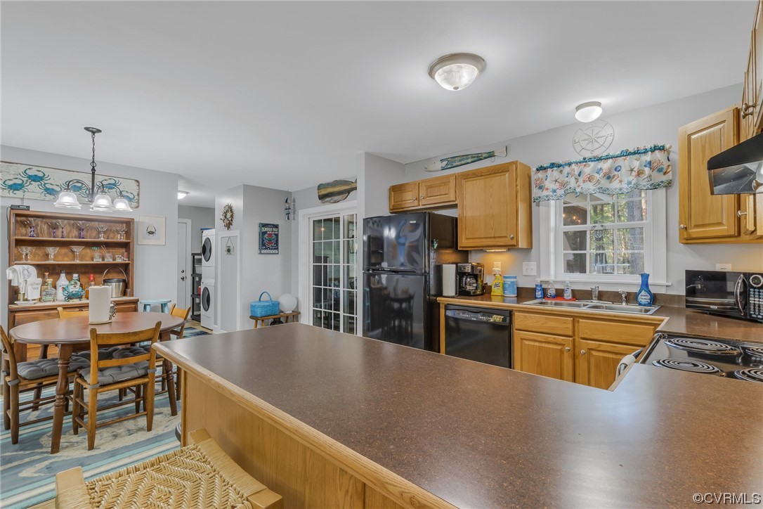 79 Lucom Point Drive Reedville, VA 22539 - Photo 26 of 32 a kitchen with stainless steel appliances granite countertop a sink stove and refrigerator
