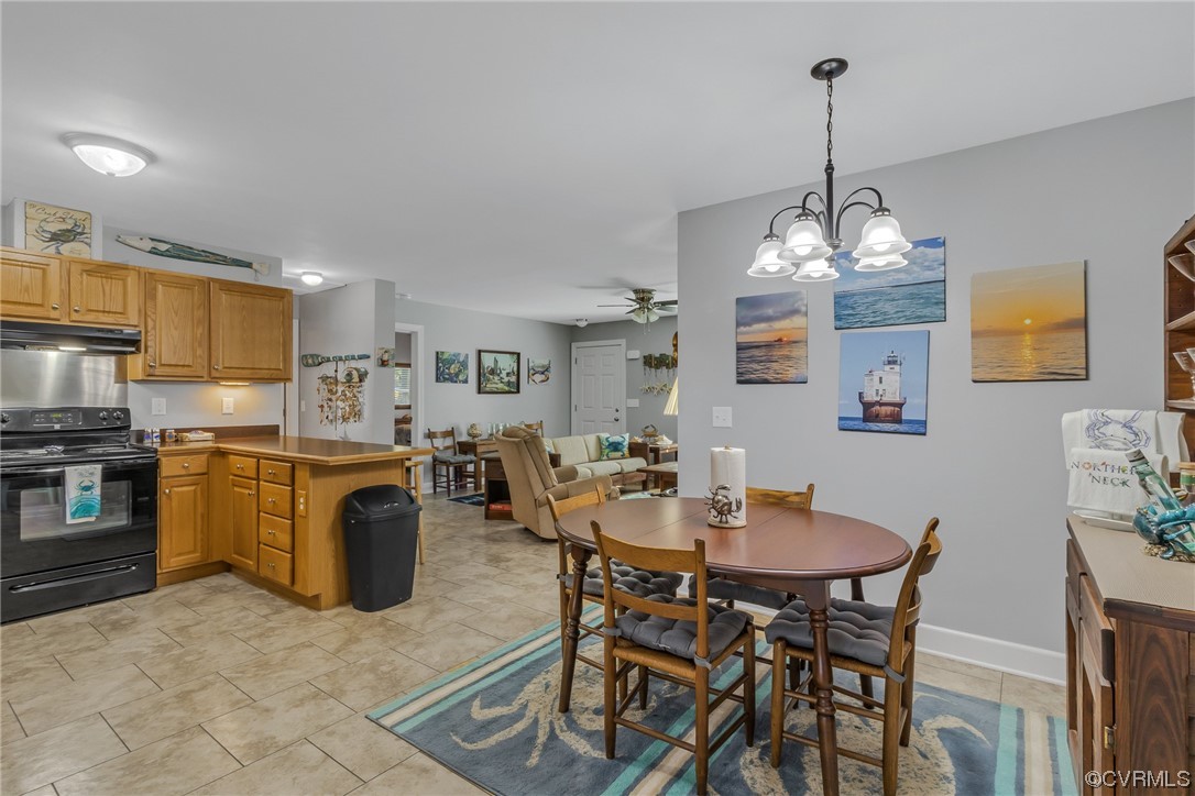 79 Lucom Point Drive Reedville, VA 22539 - Photo 31 of 32 a view of a dining room with furniture and chandelier