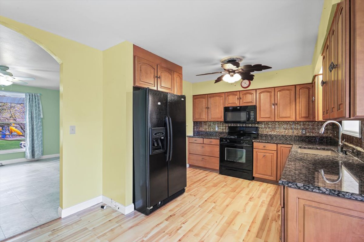 1513 Gates Drive Rantoul, IL 61866 - Photo 13 of 37 a kitchen with granite countertop a refrigerator stove and sink