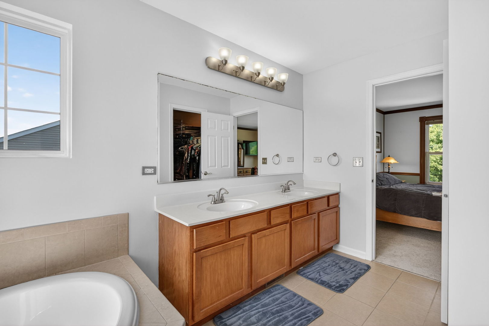 25204 Spring Street Manhattan, IL 60442 - Photo 18 of 34 a bathroom with a sink a toilet and a mirror