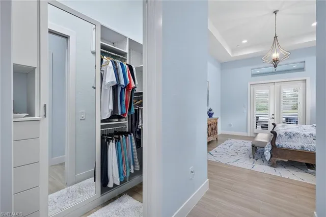 a view of a bedroom with wooden floor and furniture