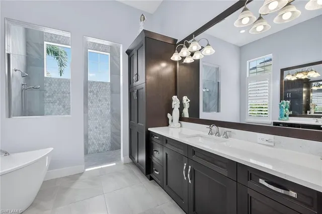 a spacious bathroom with a double vanity sink mirror and a bathtub