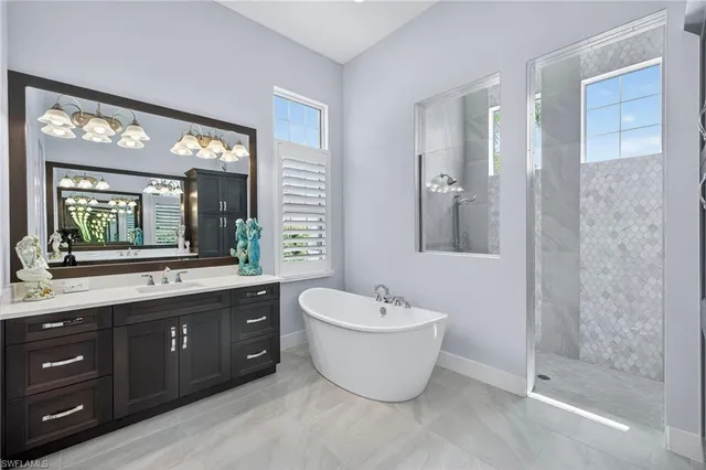 a spacious bathroom with a double vanity sink a large mirror and a bathtub