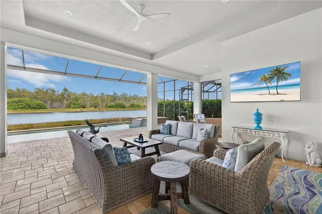 a living room with furniture and a floor to ceiling window