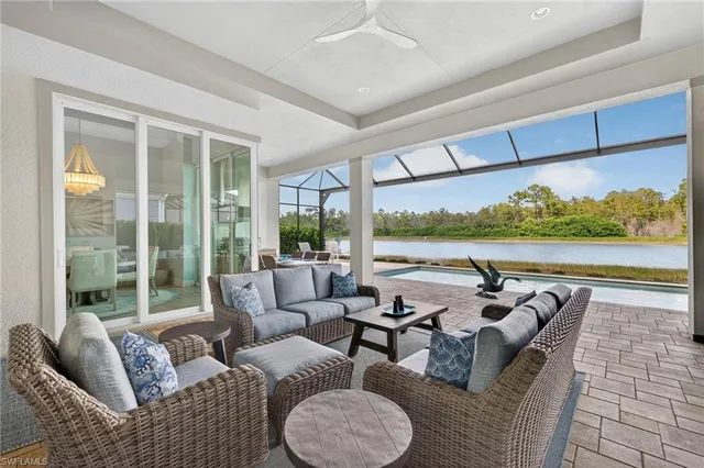 a living room with furniture and a floor to ceiling window