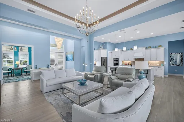 a living room with furniture and a chandelier