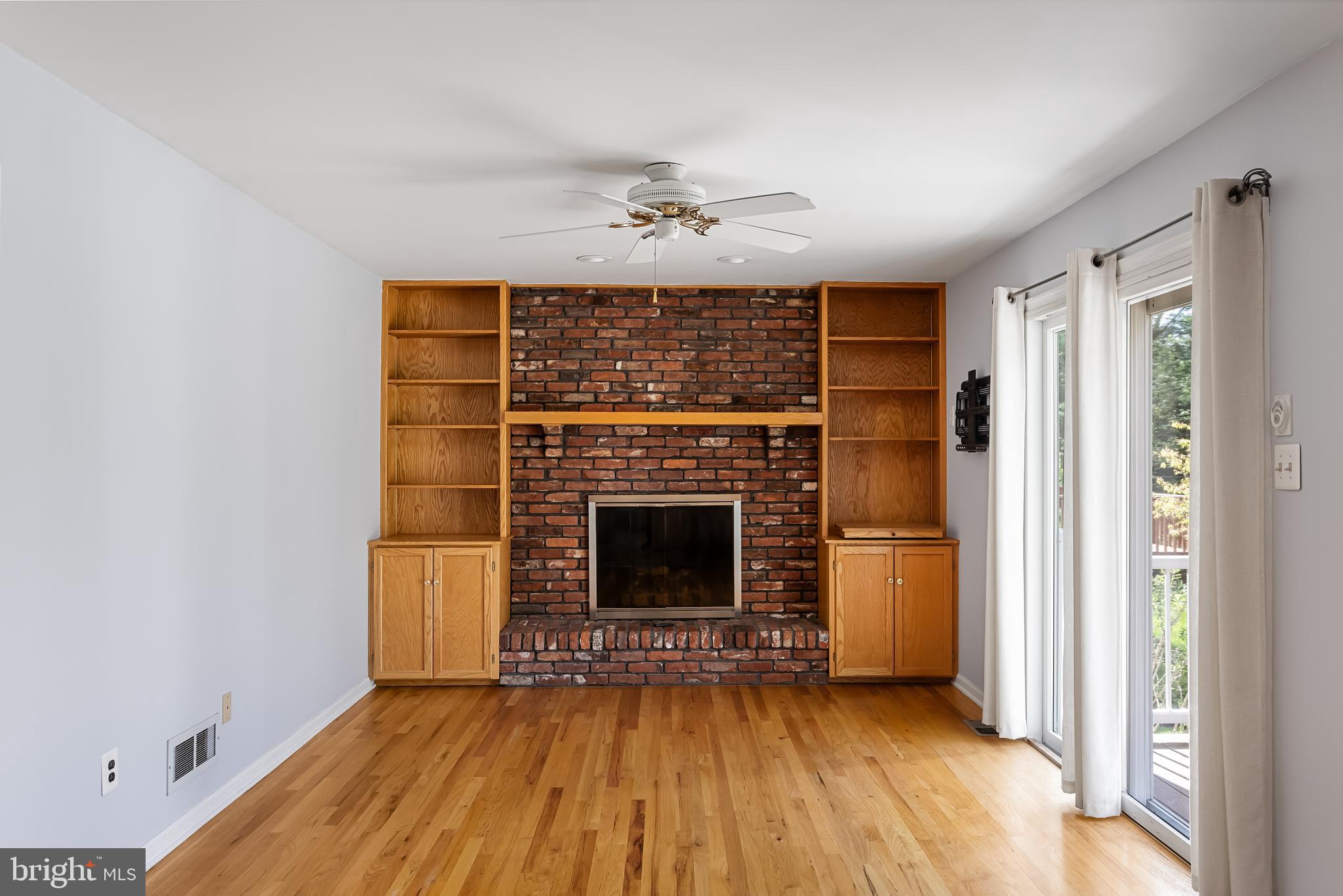 10 Mindy Drive Moorestown, NJ 08057 - Photo 14 of 29 an empty room with windows fireplace and a kitchen view