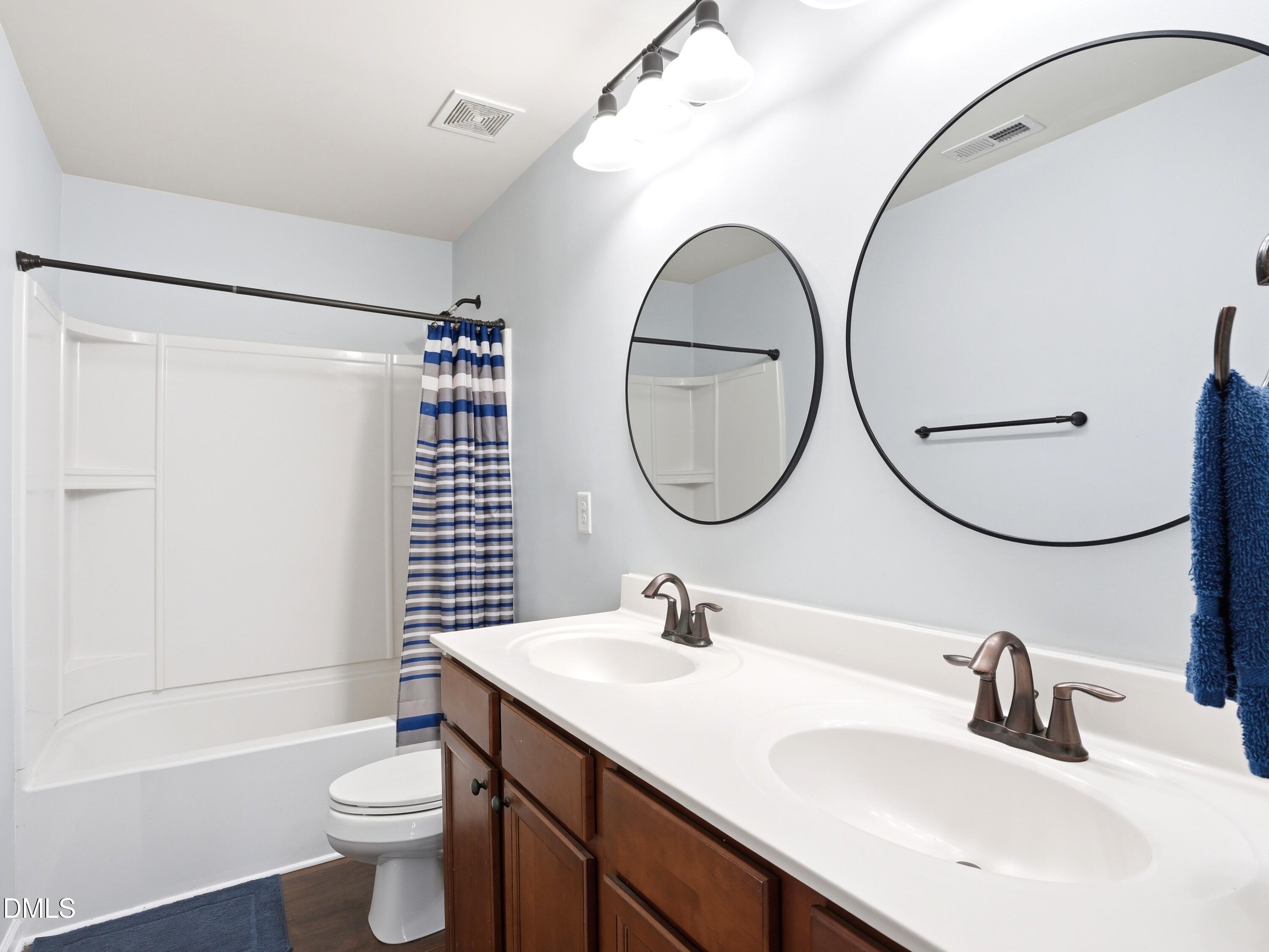 8128 Hovingham Way Raleigh, NC 27616 - Photo 26 of 40 a bathroom with a sink a toilet and a mirror