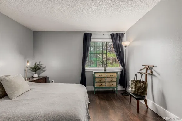 a bedroom with a bed and a chair