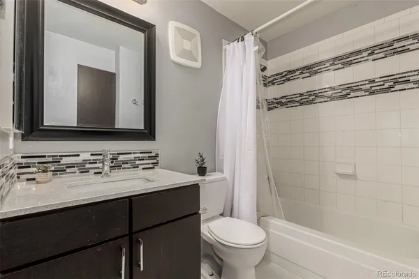 a bathroom with a sink toilet tub and shower